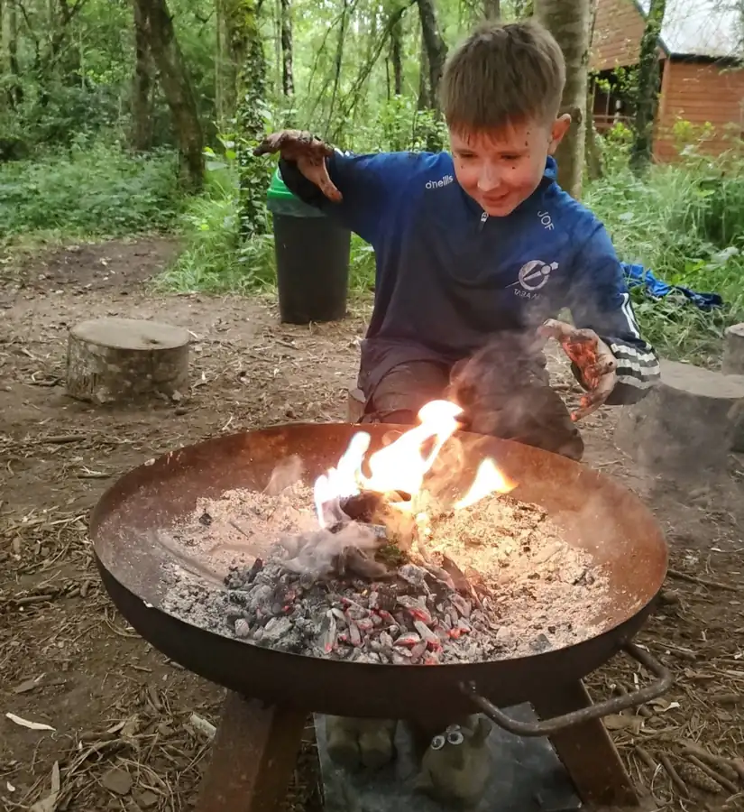 Child enjoying a campfire activity at Forest School Cloughjordan